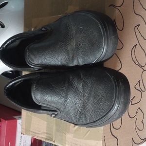 Vans all black leather slip ons